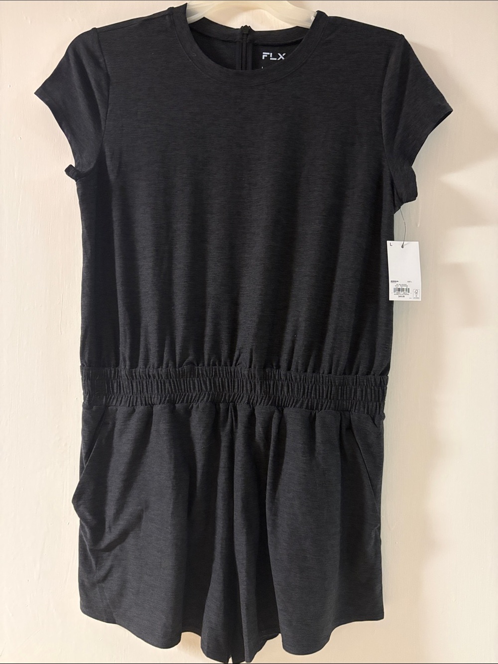 NWT FLX women’s romper size lg color in black heather. Zips in back.